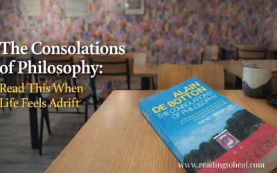The Consolations of Philosophy by Alain de Botton placed on a wooden table in a quiet café, symbolizing modern philosophy and everyday reflection